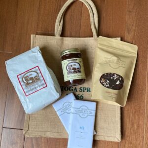 Porch package includes cake mix, fudge, chocolate bark, 2 chocolate bars. Free tote bag