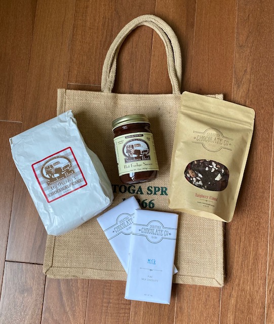 Porch package includes cake mix, fudge, chocolate bark, 2 chocolate bars. Free tote bag