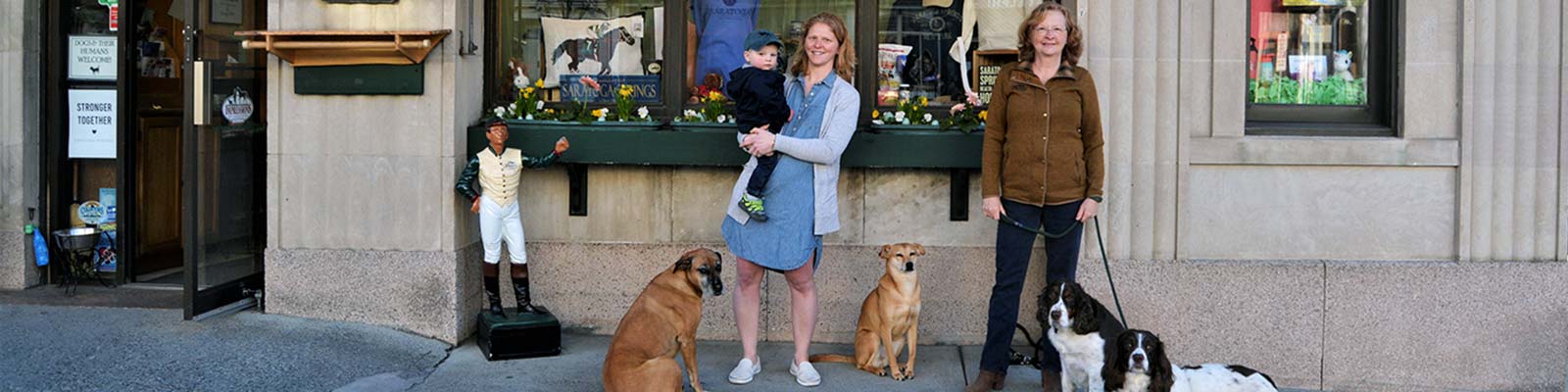 Marianne, Maddy and their dogs in front of Impressions of Saratoga