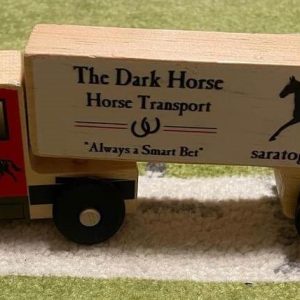 Wooden Semi Truck showing The Dark Horse Transport- Always a smart bet- a horse and Saratoga Springs- red front cab with horse on door- natural wood on rest of truck