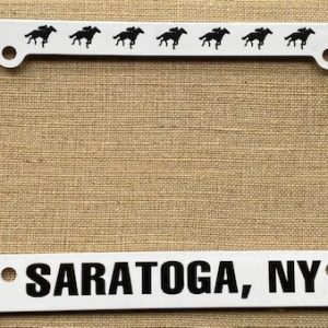 License Plate Plastic-white- black racing horses on top- Black Saratoga, NY bottom- Black jockey silk on both ends