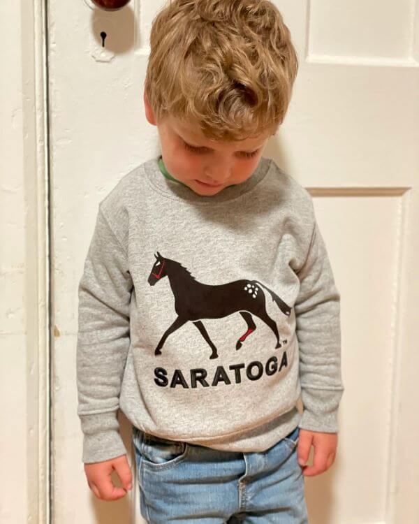 Dark horse crew sweatshirt features felt horse- embroidered Saratoga on model.