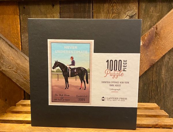 Never Underestimate Puzzle- displayed in box- 1000 pieces- features horse- jockey- never underestimate- The Dark Horse- 100 years of upsets- Established 1919