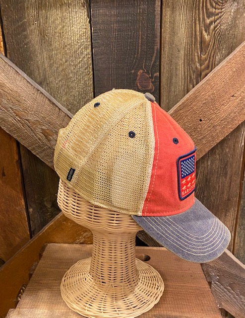 Side view of Trucker style hat with mesh back, front red with American flag of race horses and Saratoga Spring. Brim is weathered Navy.