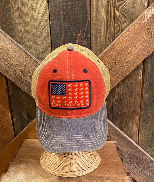 Trucker style hat with mesh back, front red with American flag of race horses and Saratoga Springs. Brim is weathered Navy.