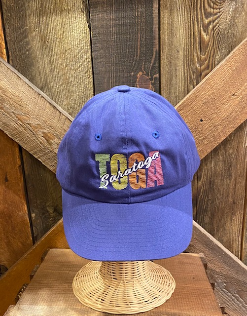 Baseball cap in Royal blue with embroidered "TOGA" in pastel colors with "Saratoga" written across