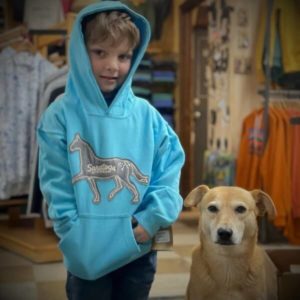 bright blue hoodie-featured on our model-applique of a horse in light grey- saratoga springs written in horse-kangaroo pocket