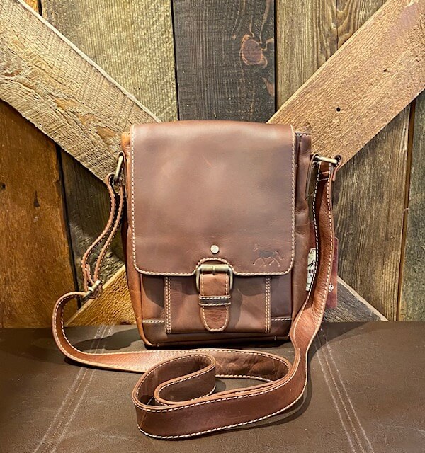 Brown leather messenger bag-front buckle- stamped with our Dark Horse logo