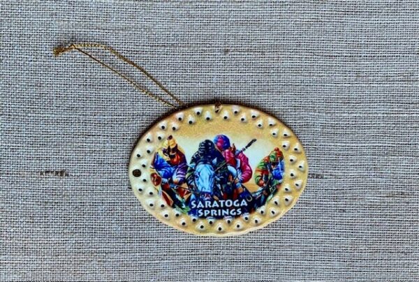 oval yellow and gold ornament featuring Race horses with jockeys- Saratoga Springs- vivid colors
