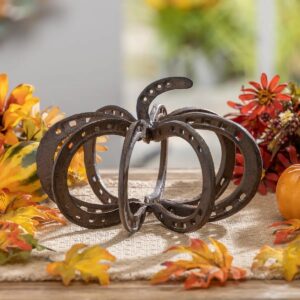 brown metal pumpkin made out of horseshoes